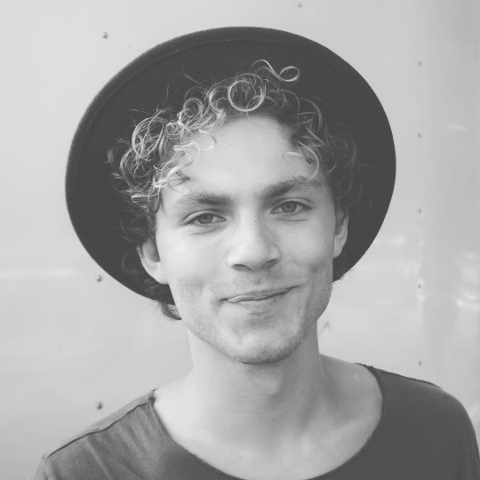 Black-and-white portrait of young man in hat
